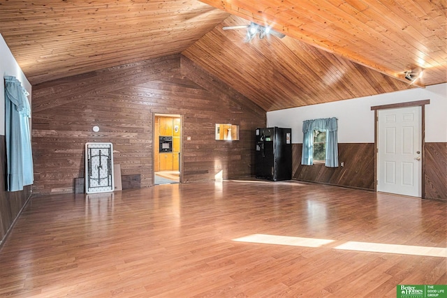 unfurnished living room featuring wooden ceiling, wooden walls, lofted ceiling, and wood-type flooring