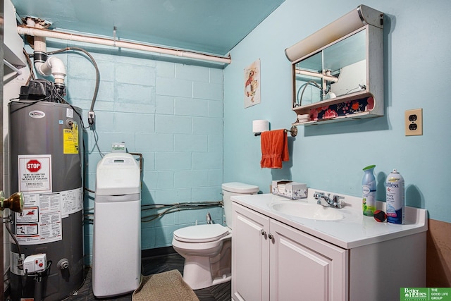 bathroom with gas water heater, vanity, and toilet