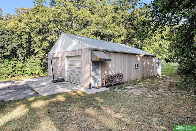 view of outbuilding featuring a lawn and a garage