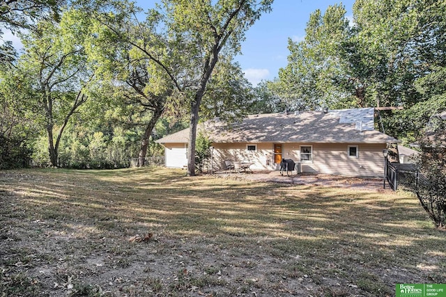 rear view of property featuring a yard