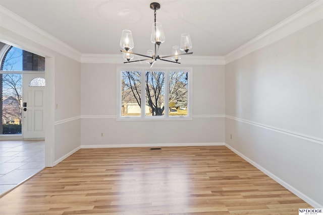 unfurnished dining area with a notable chandelier, light wood-type flooring, and crown molding