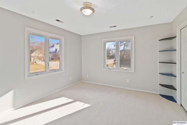 unfurnished room with light colored carpet