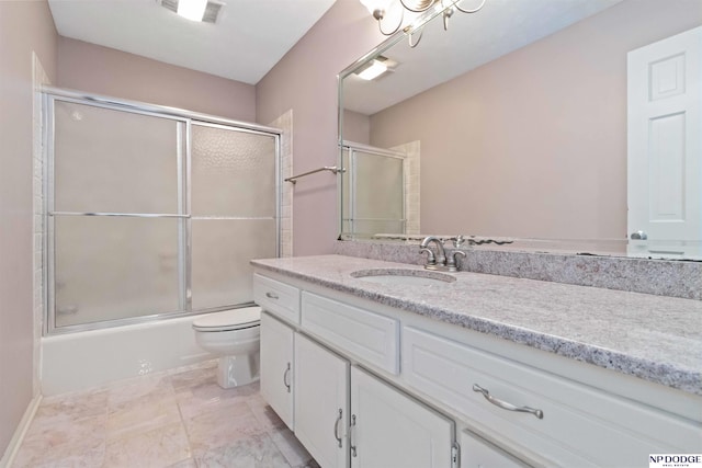 full bathroom featuring toilet, shower / bath combination with glass door, and vanity