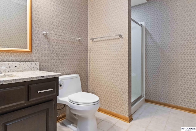 bathroom with toilet, tile patterned flooring, a shower with shower door, and vanity