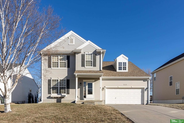 front facade with a front lawn and a garage