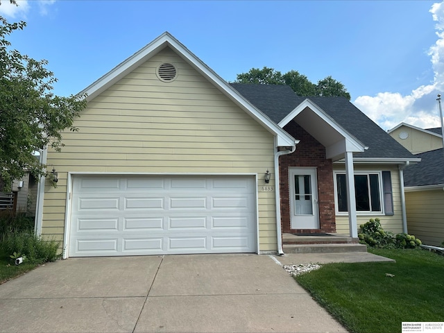 view of front of property featuring a front lawn and a garage