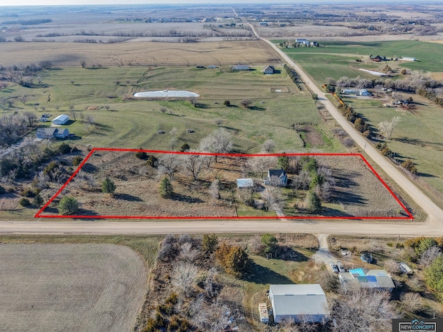 birds eye view of property with a rural view