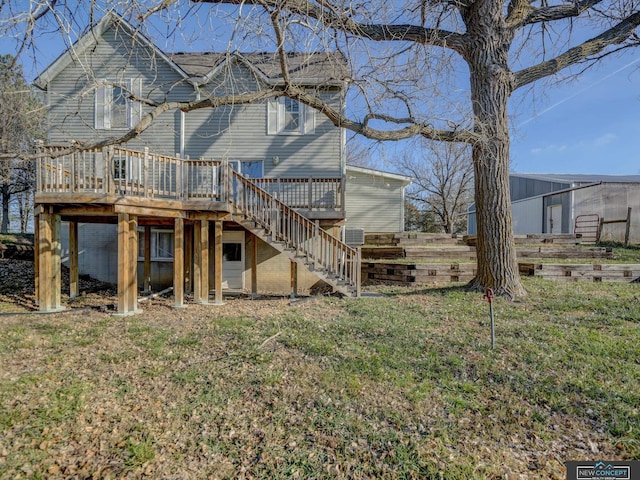 rear view of house with a deck and a yard