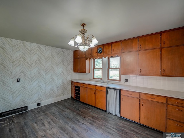 kitchen with sink, pendant lighting, an inviting chandelier, and dark hardwood / wood-style floors