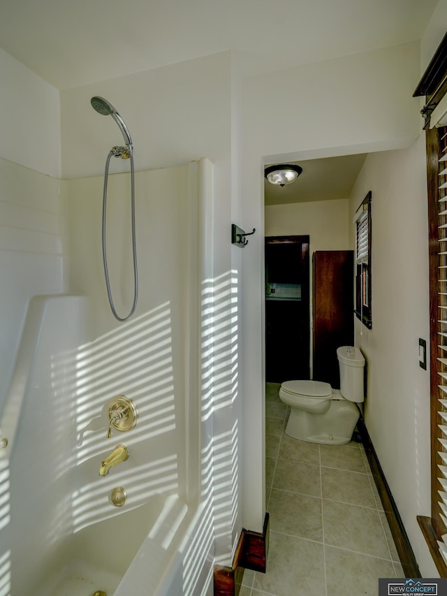 bathroom with toilet, tile patterned flooring, and walk in shower