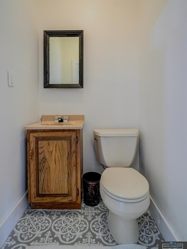 bathroom featuring toilet, vanity, and tile patterned floors