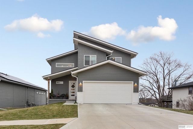 view of front of property featuring a front lawn and a garage