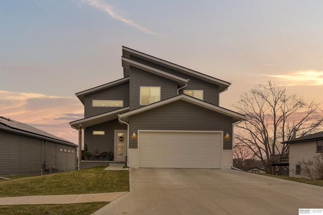 view of front of house featuring a yard and a garage