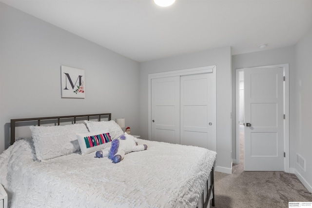 carpeted bedroom with a closet