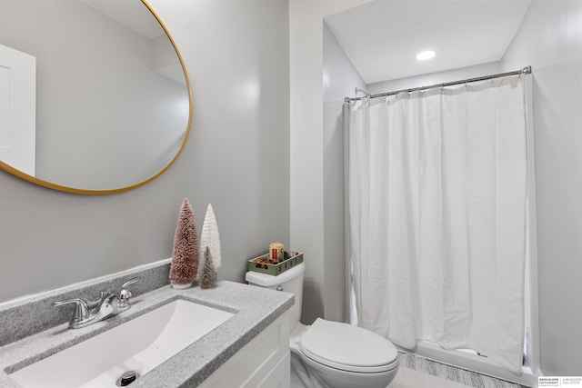 bathroom with curtained shower, vanity, and toilet