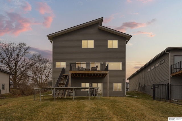 back house at dusk with a yard