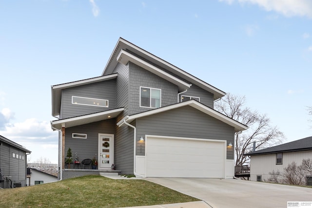 view of front of home with a front yard and a garage