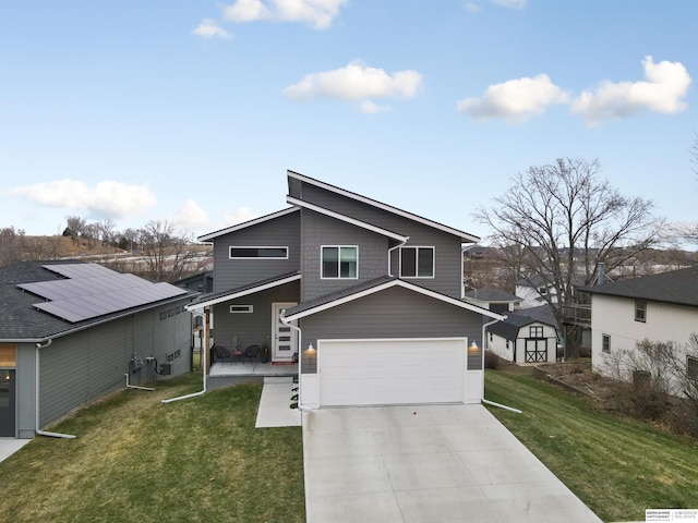 view of front of property featuring a front lawn and a garage