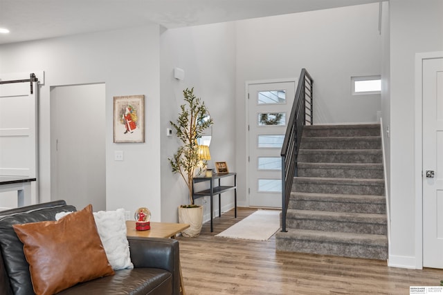 interior space featuring hardwood / wood-style flooring and a barn door