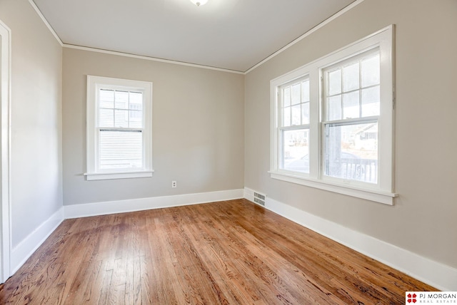 unfurnished room with ornamental molding and light hardwood / wood-style floors