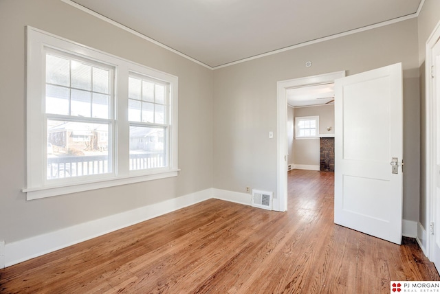 unfurnished room with hardwood / wood-style floors, ceiling fan, and crown molding