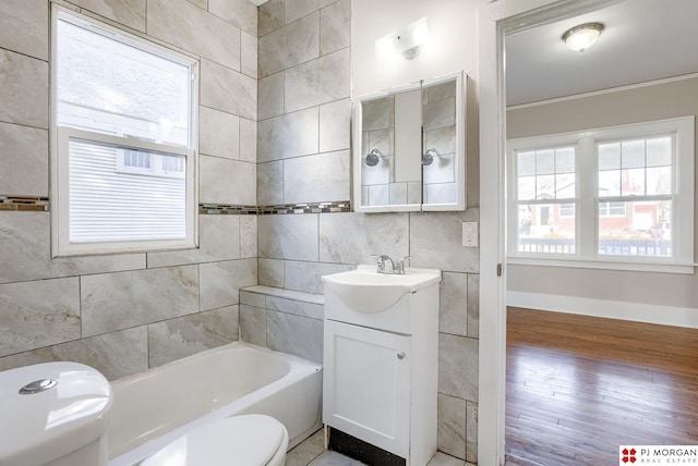 bathroom with toilet, a bathtub, hardwood / wood-style floors, backsplash, and vanity