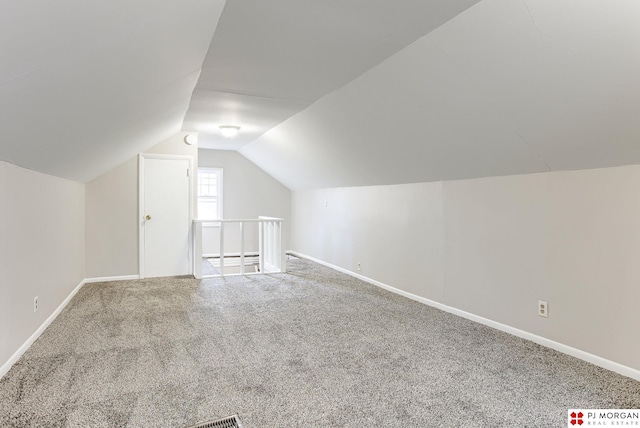 bonus room featuring vaulted ceiling and carpet flooring