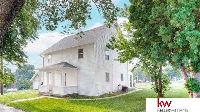 view of property exterior with a lawn and central AC