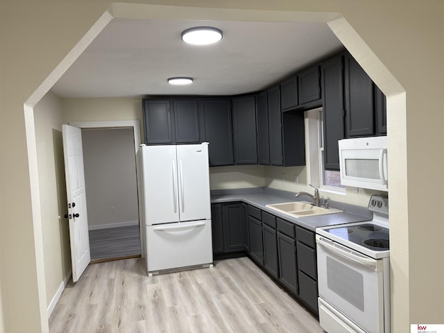 kitchen with sink, white appliances, and light wood-type flooring