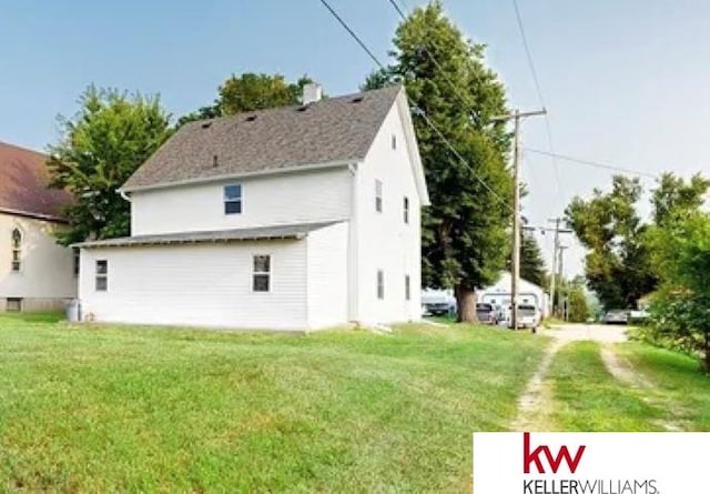 rear view of house with a lawn