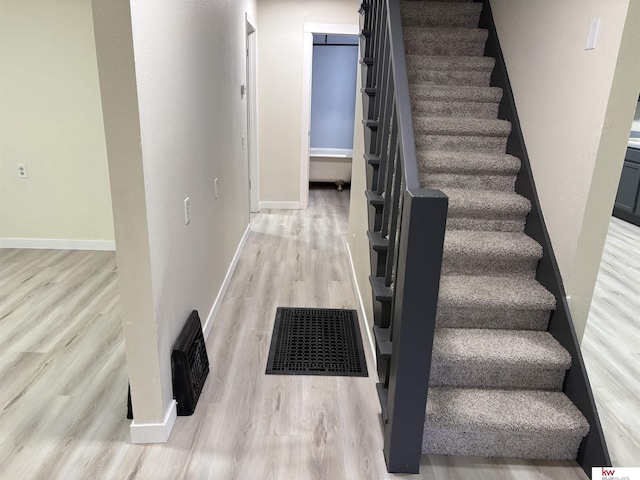 stairs featuring wood-type flooring