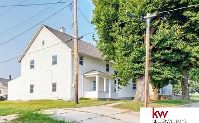 view of side of property with a lawn