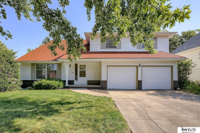 view of front of property with a front yard and a garage