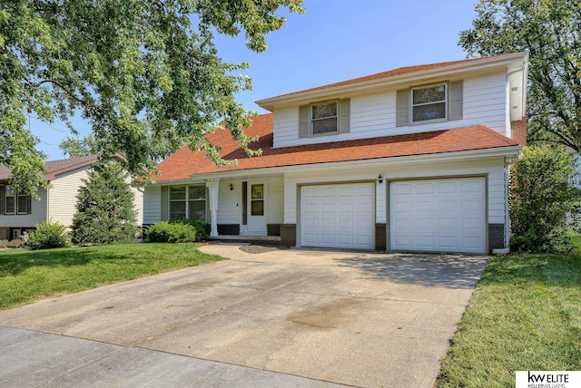 view of front of property with a front yard and a garage