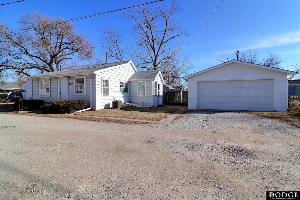 view of front of house with central AC unit and a garage