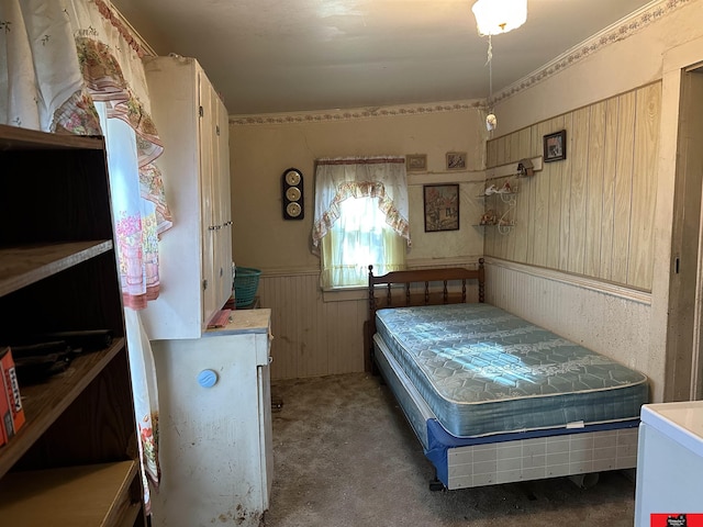 carpeted bedroom with wooden walls