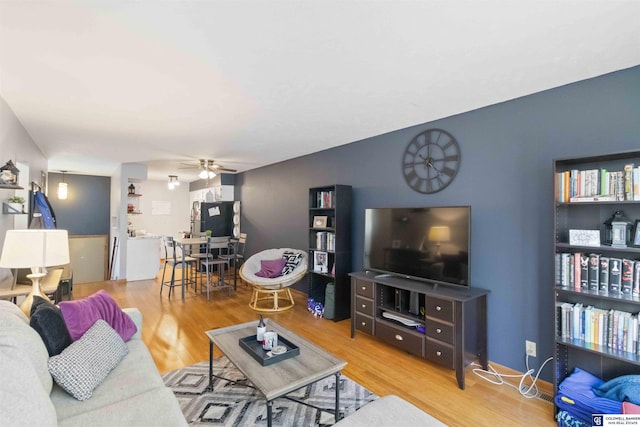 living room featuring ceiling fan and wood-type flooring