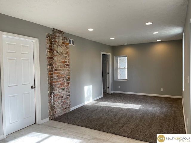 spare room with light colored carpet