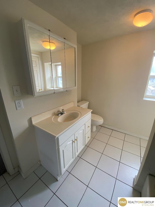 bathroom featuring vanity, tile patterned flooring, and toilet