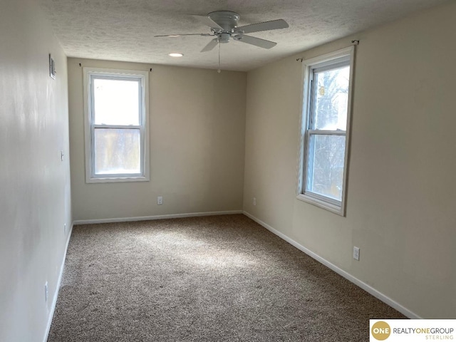 carpeted empty room with a textured ceiling and ceiling fan