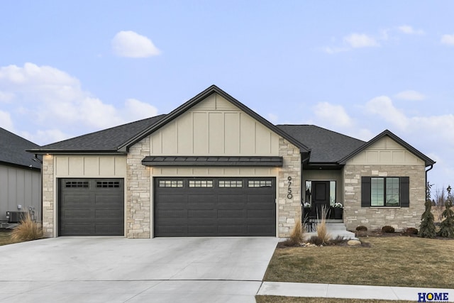 view of front of house with central AC unit and a garage