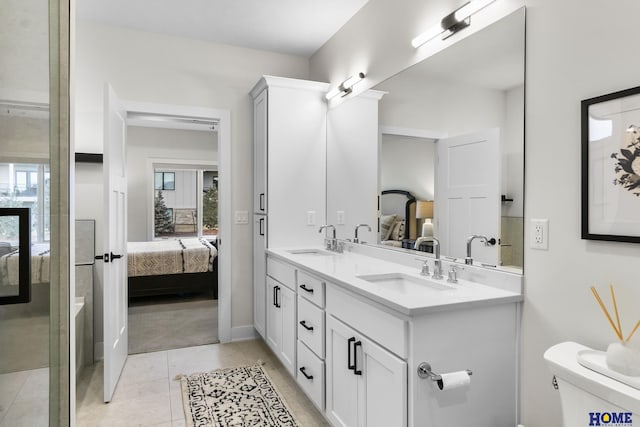 bathroom with toilet, tile patterned flooring, a healthy amount of sunlight, and vanity