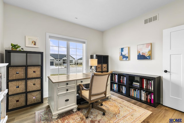 office with light hardwood / wood-style floors