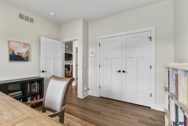 home office with dark hardwood / wood-style floors