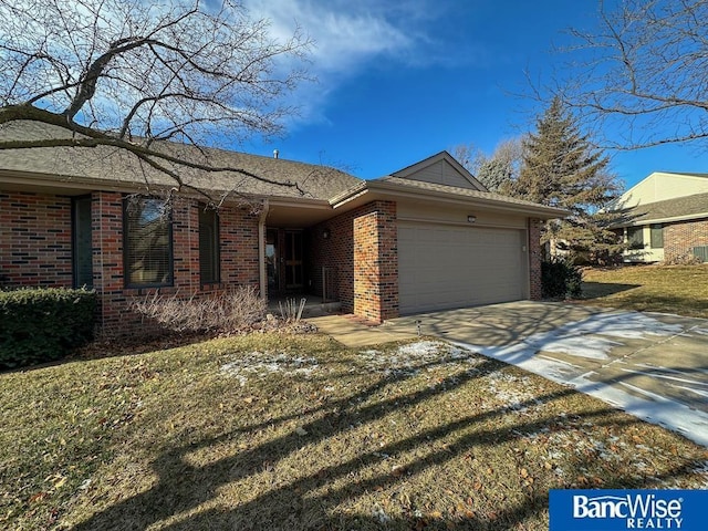 single story home with a garage and a front lawn