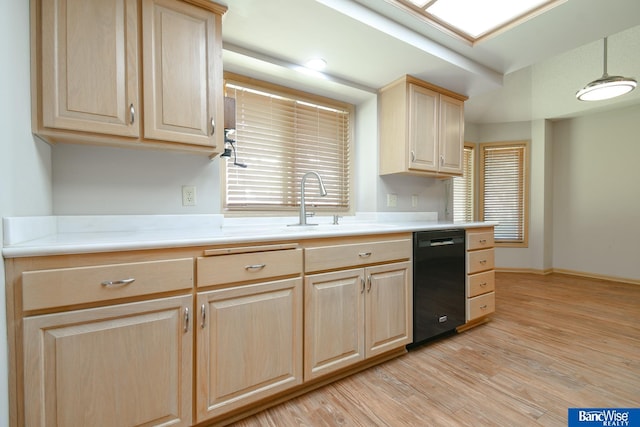 kitchen with sink, black dishwasher, light brown cabinets, light hardwood / wood-style flooring, and pendant lighting