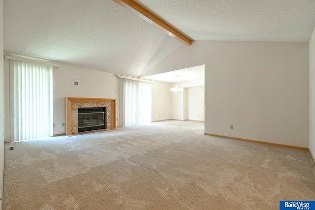 unfurnished living room with a textured ceiling, light carpet, vaulted ceiling with beams, and a chandelier