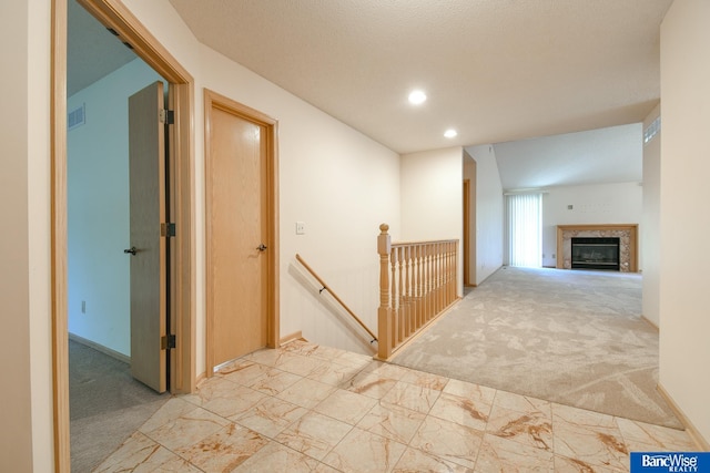 hall featuring light colored carpet