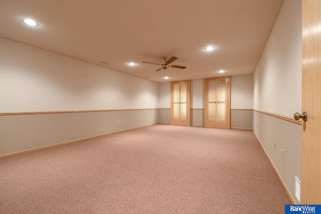 carpeted spare room with ceiling fan