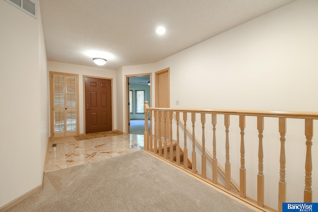 hallway featuring a textured ceiling